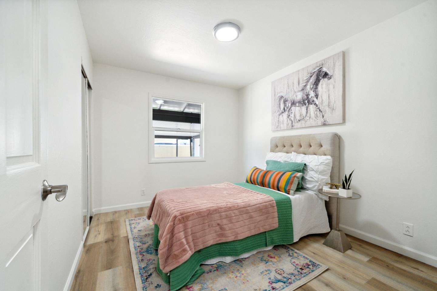 1324 Peralta Road Pacifica, CA 94044 - Photo 11 of 25 a bedroom with a bed and a painting on the wall