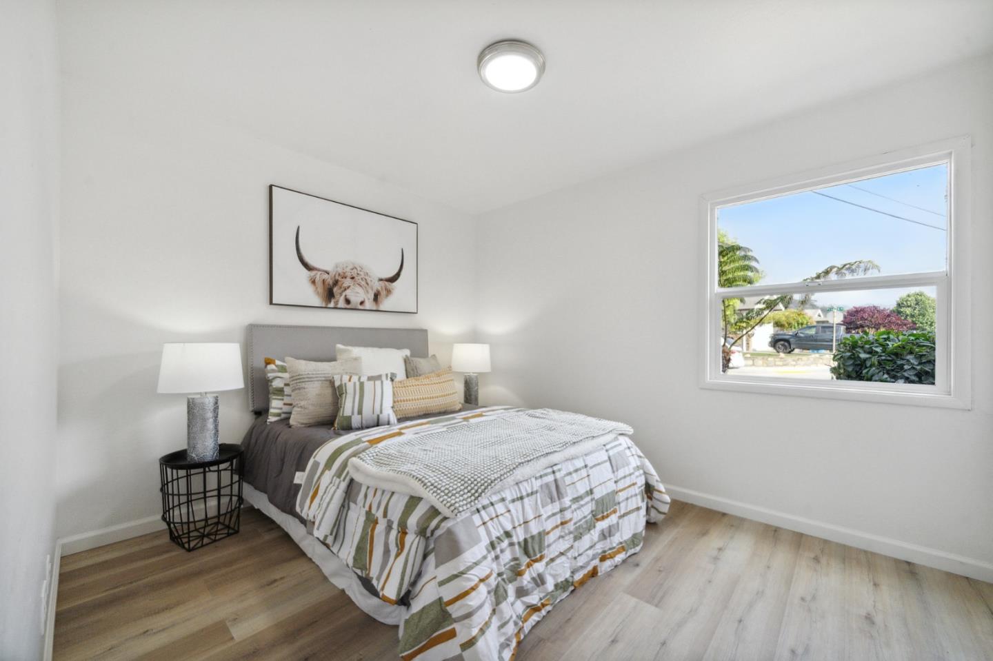 1324 Peralta Road Pacifica, CA 94044 - Photo 13 of 25 a bedroom with a bed and painting on the wall