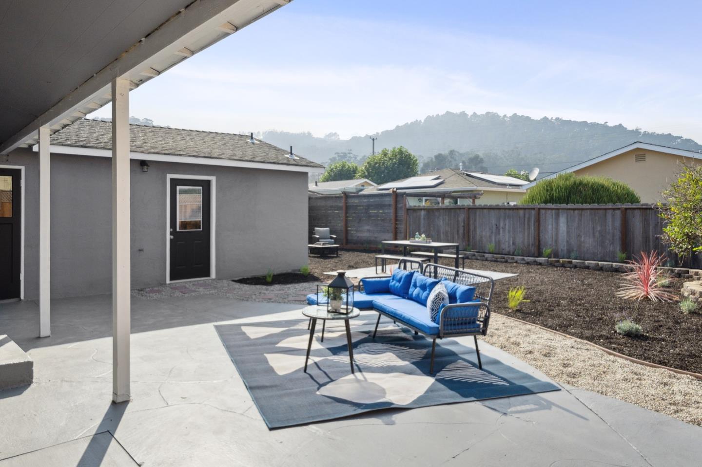 1324 Peralta Road Pacifica, CA 94044 - Photo 22 of 25 a backyard of a house with fountain table and chairs