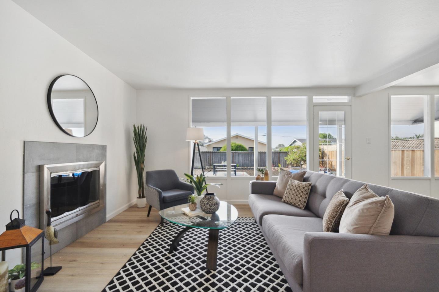 1324 Peralta Road Pacifica, CA 94044 - Photo 3 of 25 a living room with furniture a large window and a fireplace