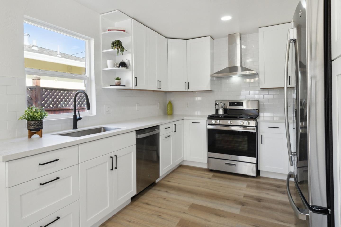1324 Peralta Road Pacifica, CA 94044 - Photo 6 of 25 a kitchen with white cabinets and white appliances