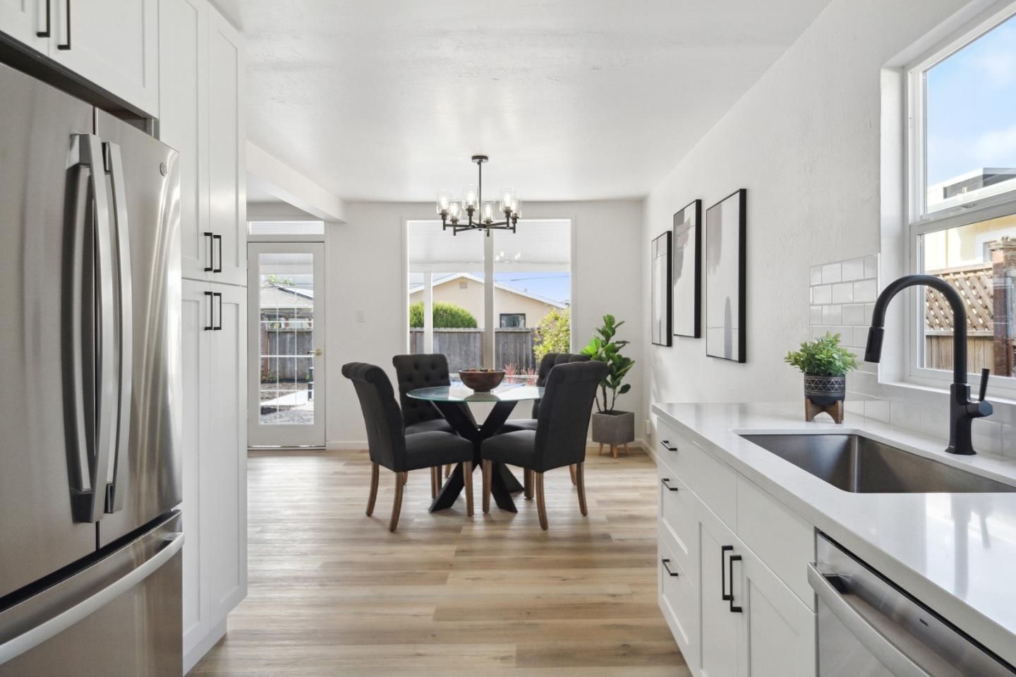1324 Peralta Road Pacifica, CA 94044 - Photo 8 of 25 a kitchen with stainless steel appliances granite countertop a dining table chairs and granite counter tops