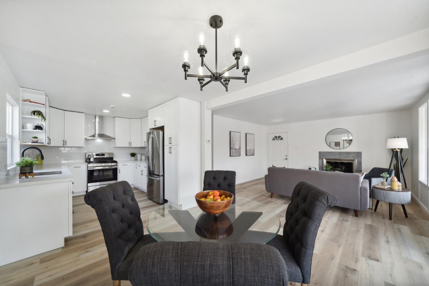 1324 Peralta Road Pacifica, CA 94044 - Photo 9 of 25 a view of a dining room with furniture a chandelier and wooden floor