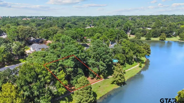 an aerial view of a houses with a yard