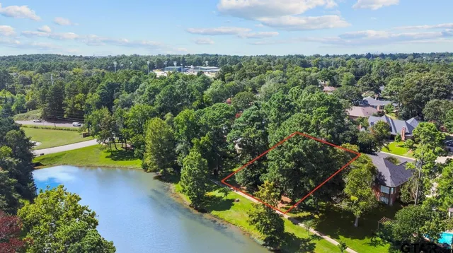 an aerial view of a houses with a yard