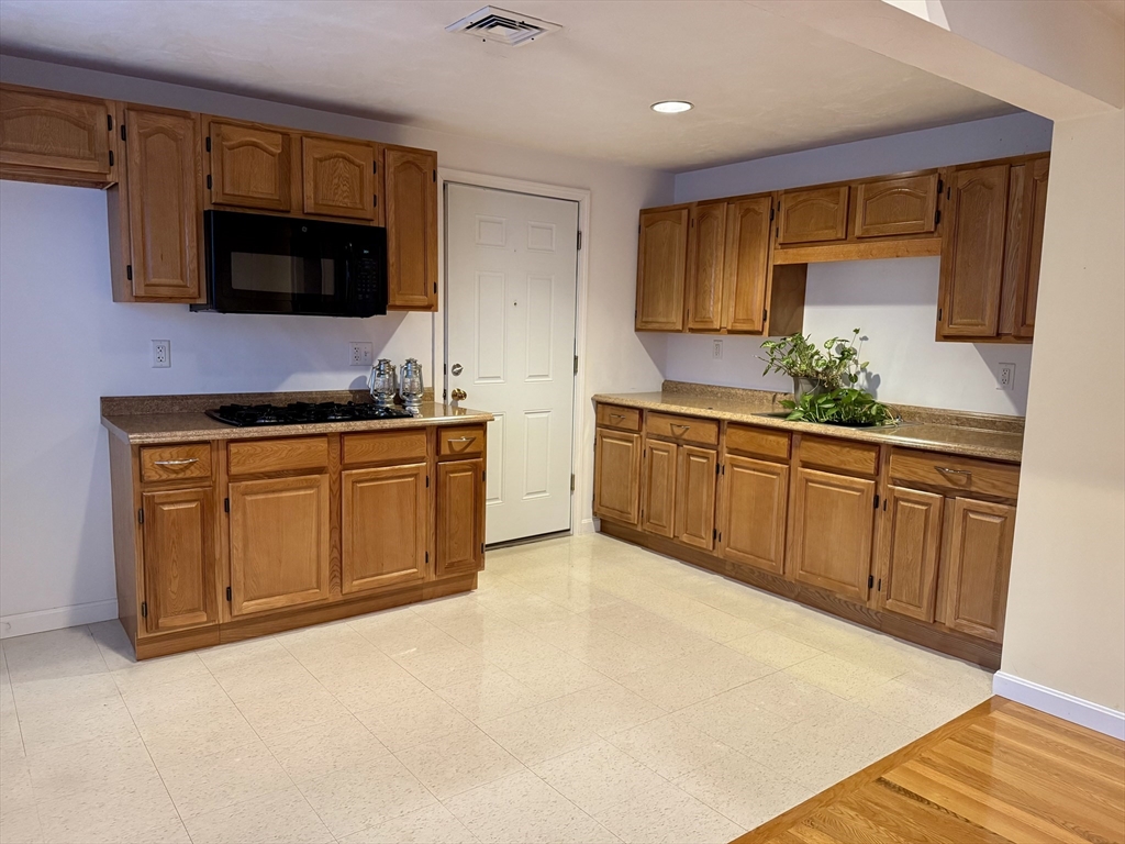 a kitchen with stainless steel appliances a sink and a microwave
