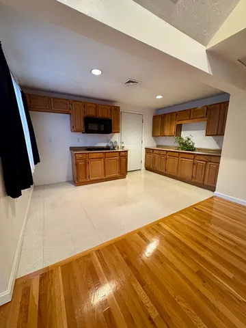 a spacious bedroom with a bed and a flat screen tv
