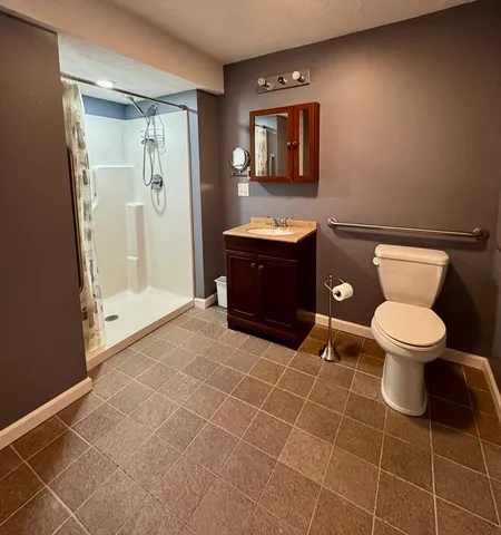 a bathroom with a toilet a sink and mirror