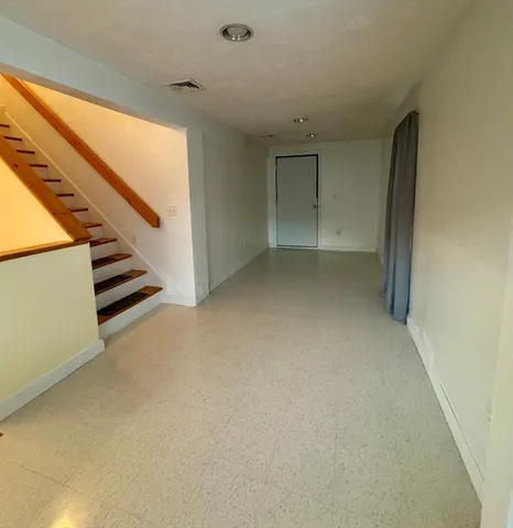a view of an empty room with stairs