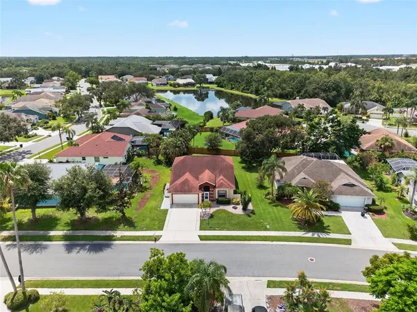 an aerial view of residential houses with outdoor space and river