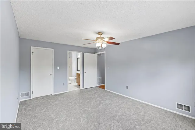 a view of a livingroom with a chandelier fan