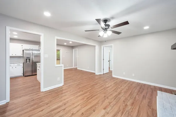 a view of an empty room with a kitchen