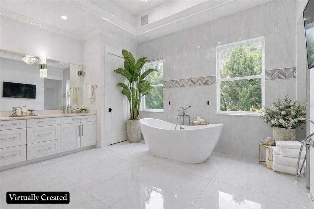 8241 Cass Road Zephyrhills, FL 33540 - Photo 38 of 97 a spacious bathroom with a bathtub a sink and a window