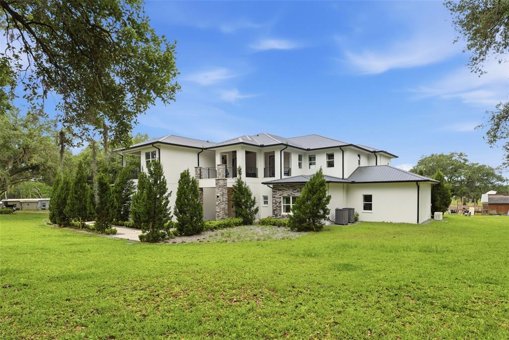 8241 Cass Road Zephyrhills, FL 33540 - Photo 4 of 97 front view of a house with a yard