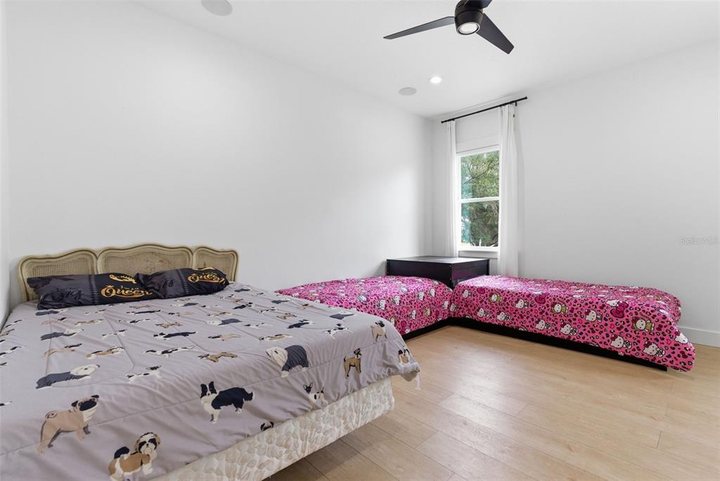 8241 Cass Road Zephyrhills, FL 33540 - Photo 71 of 97 a bedroom with two beds and a window