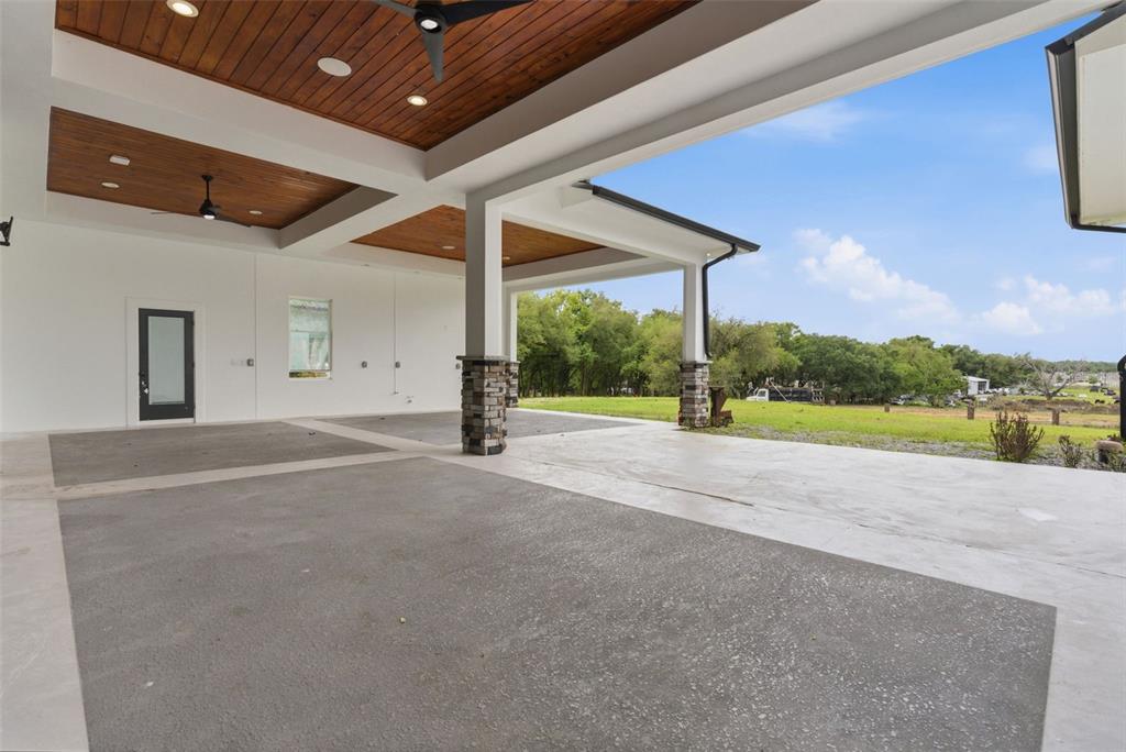 8241 Cass Road Zephyrhills, FL 33540 - Photo 73 of 97 a view of a house with porch and a yard