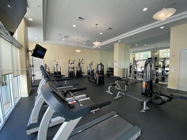 2775 Northeast 187th Street, Unit 311 Aventura, FL 33180 - Photo 16 of 28 a room with gym equipment and a view of living room