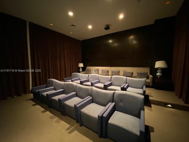 2775 Northeast 187th Street, Unit 311 Aventura, FL 33180 - Photo 19 of 28 a media room with lots of chairs and a projector screen