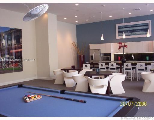 2775 Northeast 187th Street, Unit 311 Aventura, FL 33180 - Photo 23 of 28 a living room with lots of furniture and a rug