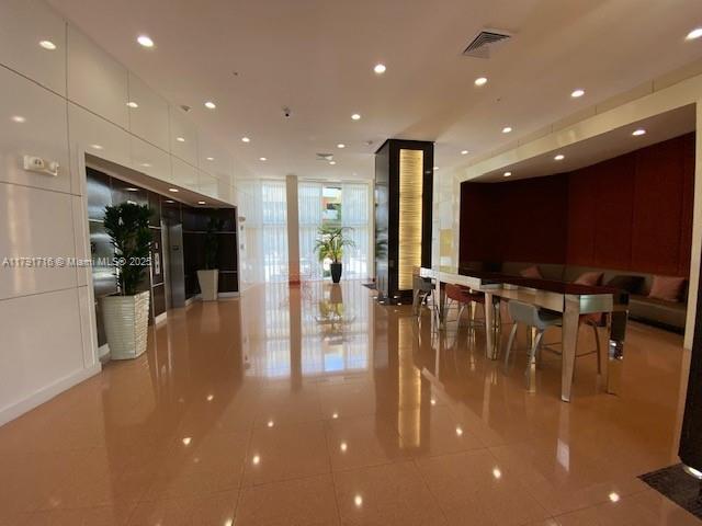 2775 Northeast 187th Street, Unit 311 Aventura, FL 33180 - Photo 28 of 28 a view of dining room with floor to ceiling window and kitchen