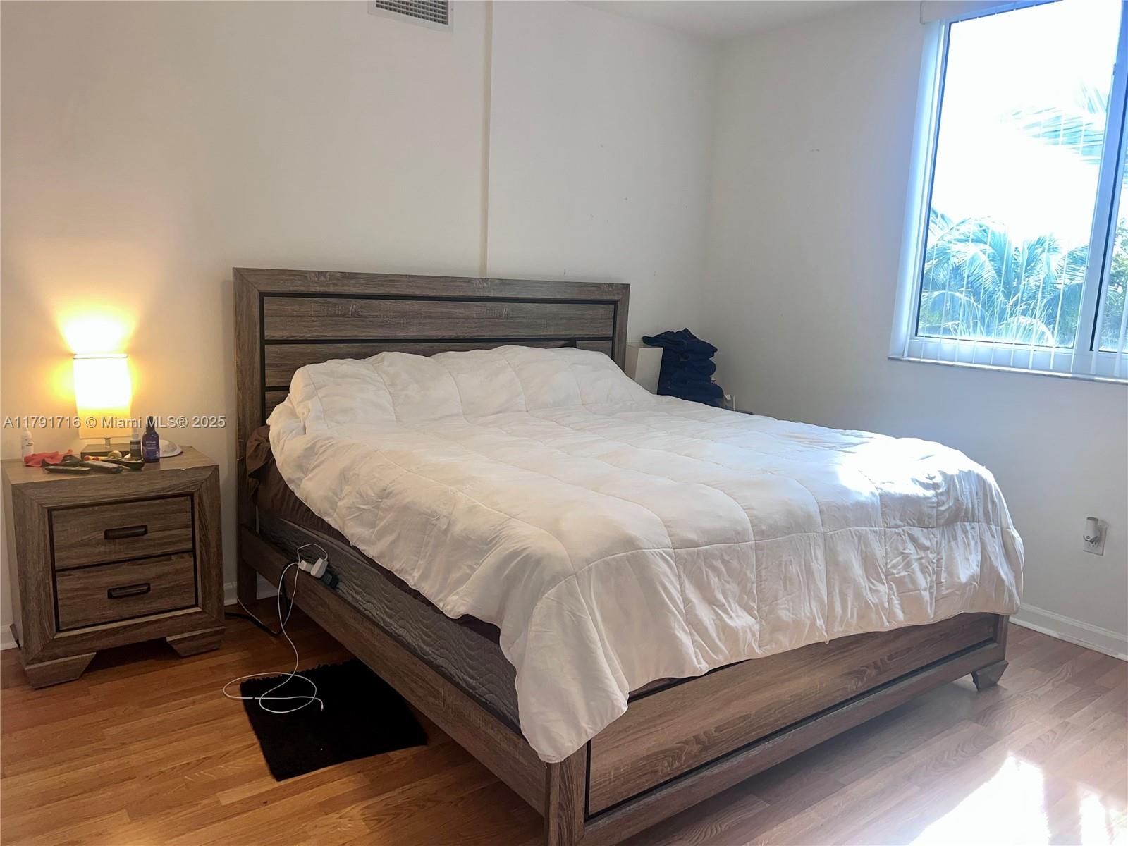 2775 Northeast 187th Street, Unit 311 Aventura, FL 33180 - Photo 4 of 28 a bed sitting in a bedroom next to a window