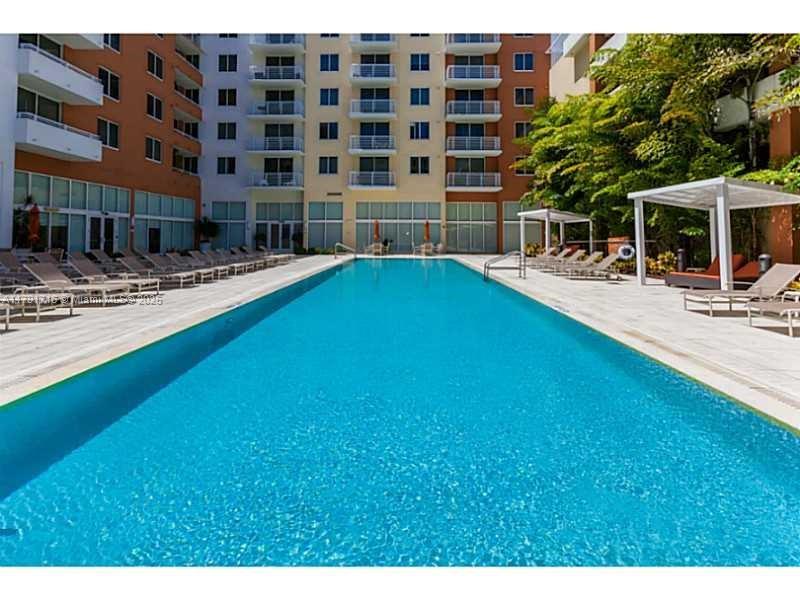 2775 Northeast 187th Street, Unit 311 Aventura, FL 33180 - Photo 10 of 28 a swimming pool with outdoor seating and yard