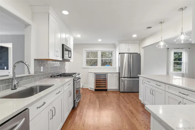 a kitchen with stainless steel appliances granite countertop a stove and a sink