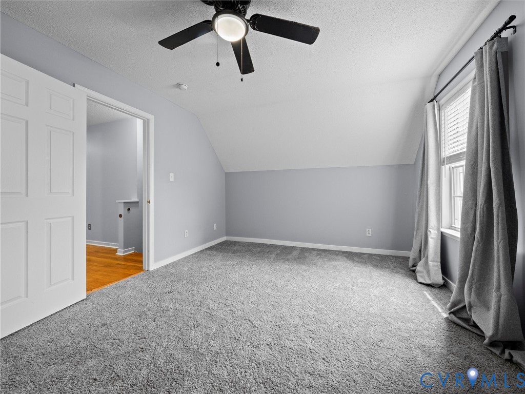 6712 Hedges Road Richmond, VA 23224 - Photo 17 of 34 Room featuring sloped ceilings, a ceiling fan with