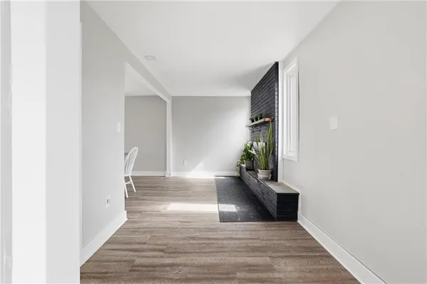 a view of an empty room with closet and a window