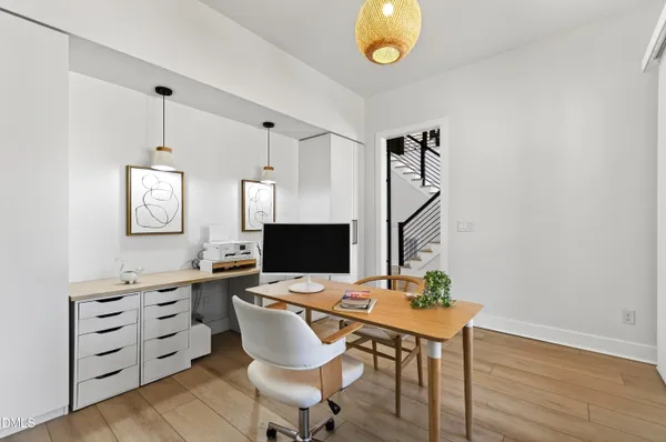 a living room with furniture a flat screen tv and a floor to ceiling window
