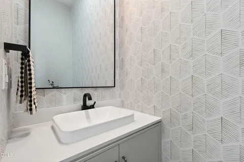a bathroom with a tub sink shower and mirror