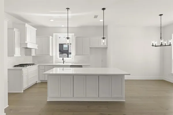 a kitchen with kitchen island white cabinets and white appliances