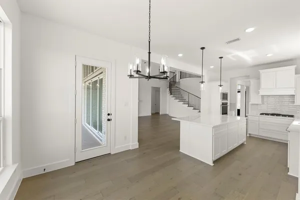 a view of kitchen with sink and refrigerator