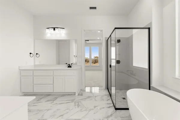a spacious bathroom with a shower sink and mirror