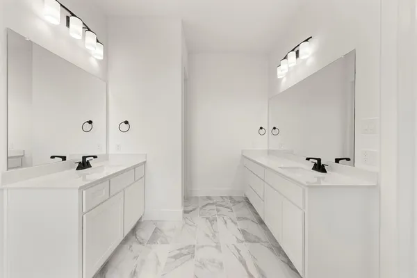 a bathroom with a sink mirror and vanity