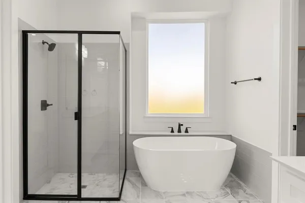 a white bath tub sitting next to a bathroom sink