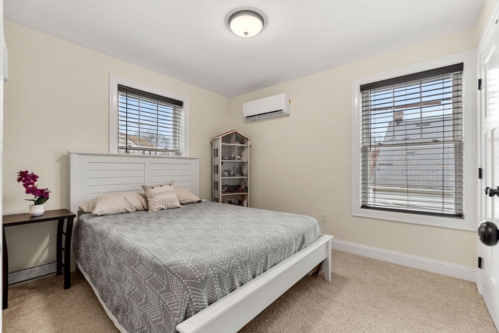 22 Pond Street, Unit 2 Amesbury, MA 01913 - Photo 22 of 40 a bedroom with a bed and a window