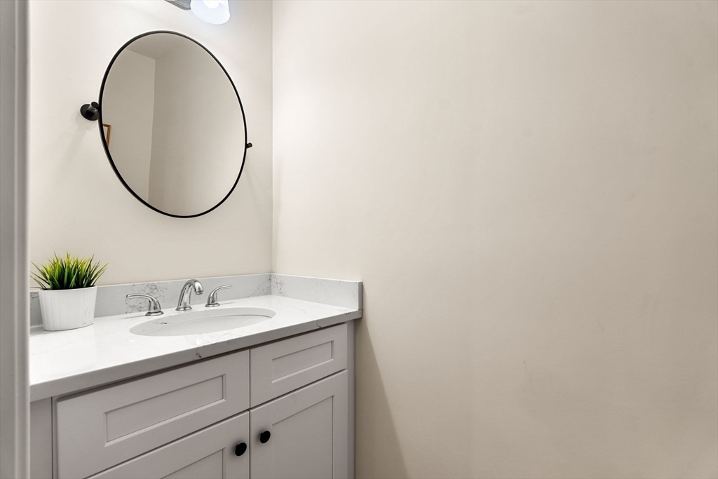 22 Pond Street, Unit 2 Amesbury, MA 01913 - Photo 30 of 40 a bathroom with a sink and a mirror