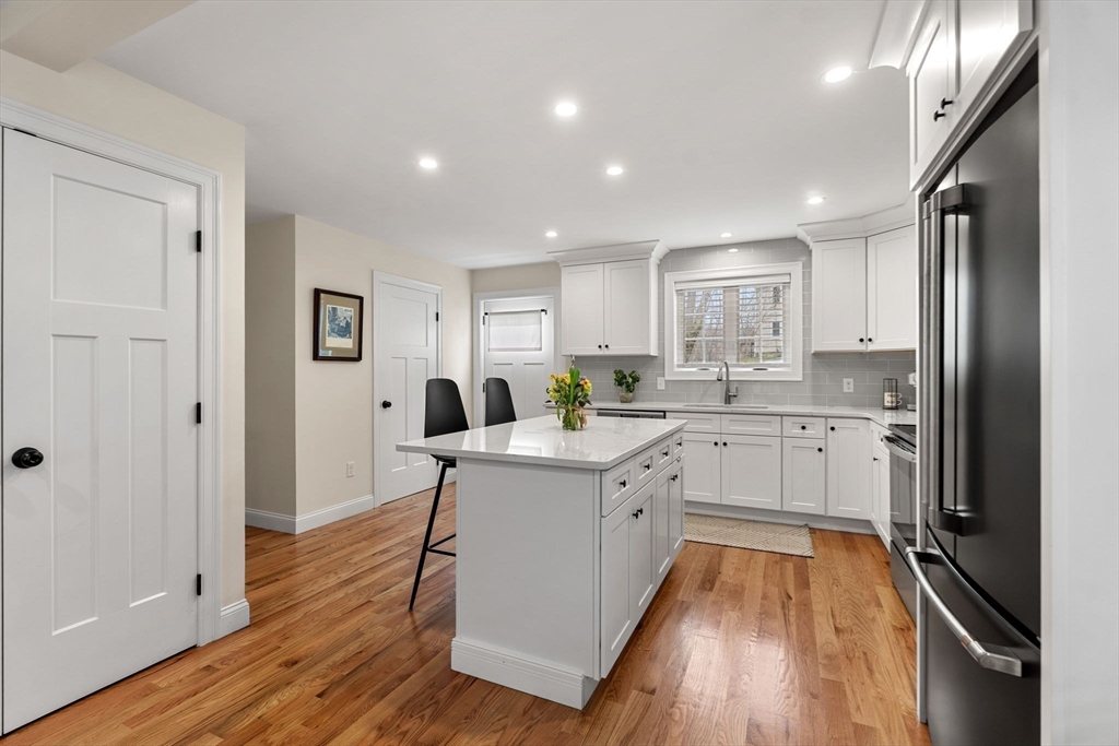 22 Pond Street, Unit 2 Amesbury, MA 01913 - Photo 6 of 40 a kitchen with white cabinets and stainless steel appliances