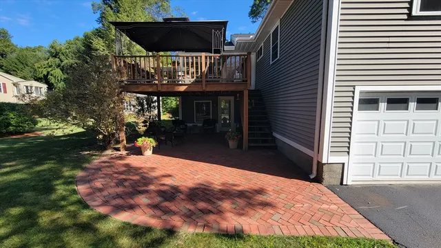 a view of a house with backyard and sitting area