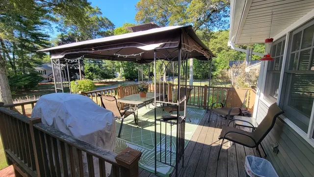 a view of outdoor dining space with a patio and wooden floor