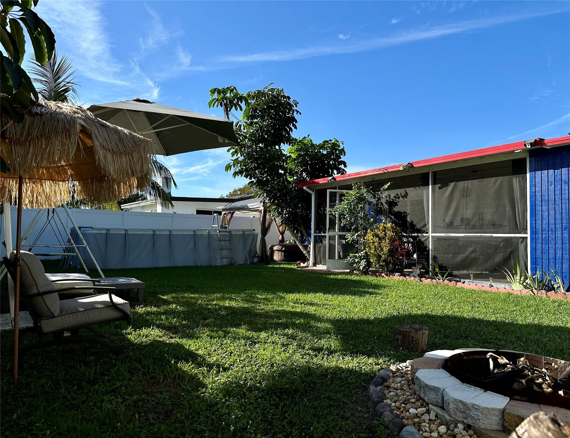 610 Southwest 76th Terrace North Lauderdale, FL 33068 - Photo 40 of 49 a view of a backyard with plants and a patio