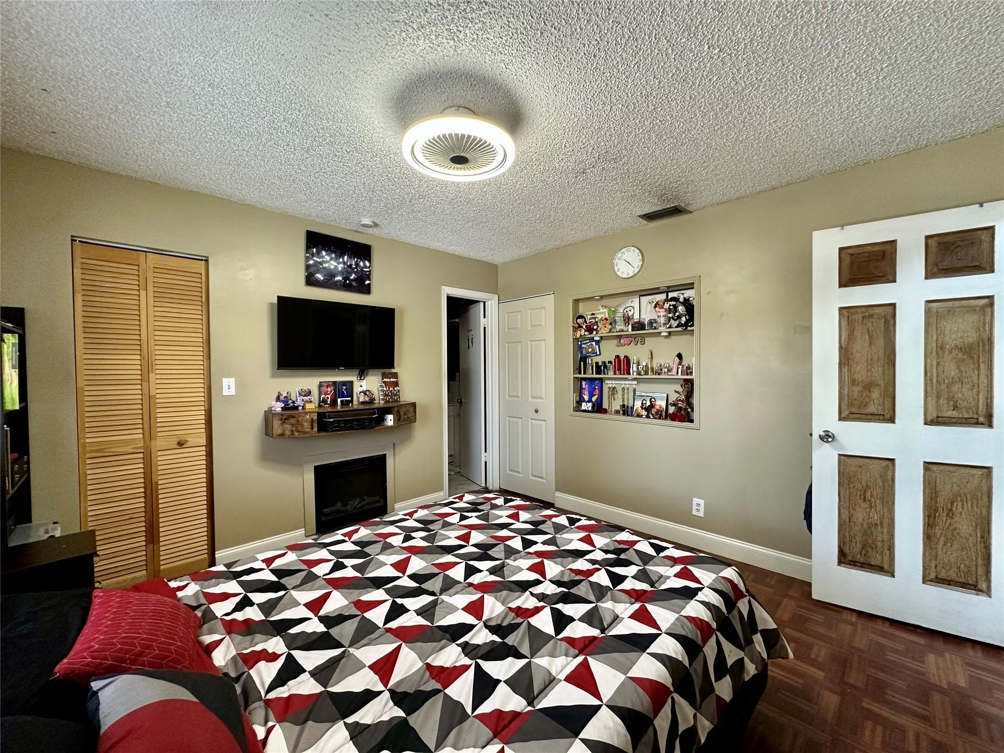 610 Southwest 76th Terrace North Lauderdale, FL 33068 - Photo 4 of 49 a bedroom with a bed and a flat screen tv