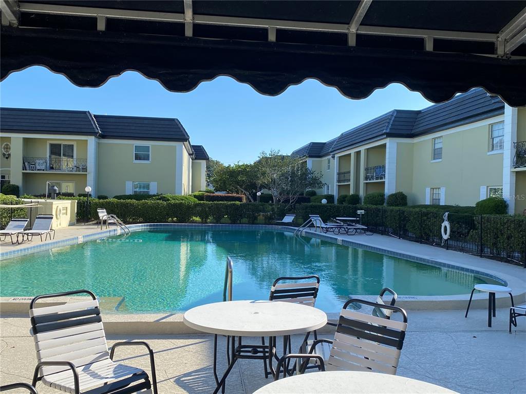 1500 Gay Road, Unit 17D Winter Park, FL 32789 - Photo 25 of 34 a view of a chairs and table in the patio next to a yard