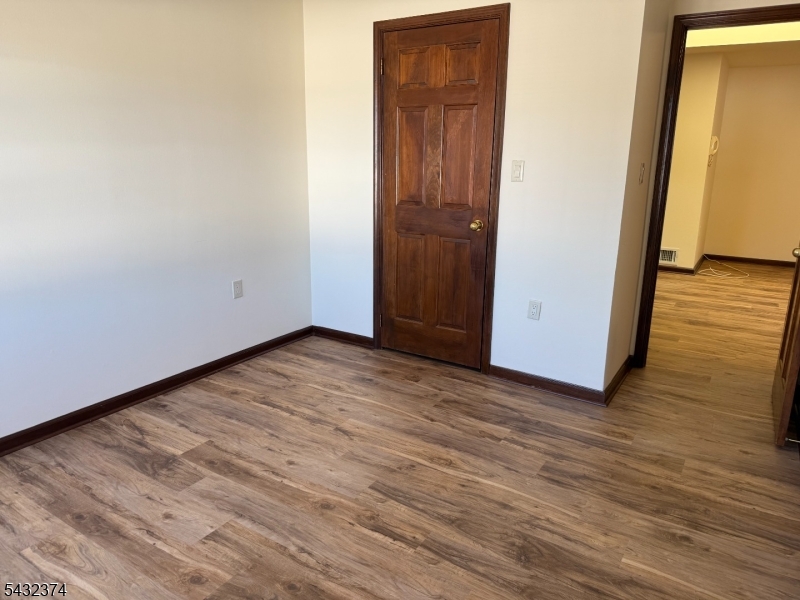 551 Valley Road, Unit 2 Montclair, NJ 07043 - Photo 4 of 9 a view of an empty room with wooden floor and closet