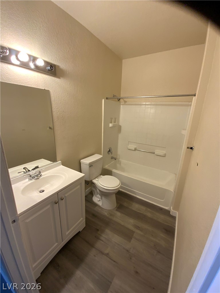 4730 East Craig Road, Unit 1154 Las Vegas, NV 89115 - Photo 7 of 13 A well-appointed bathroom features durable wood-look flooring and a functional shower-over-tub setup.