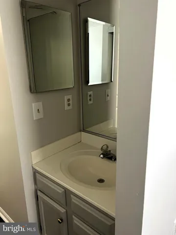 a bathroom with a sink and mirror