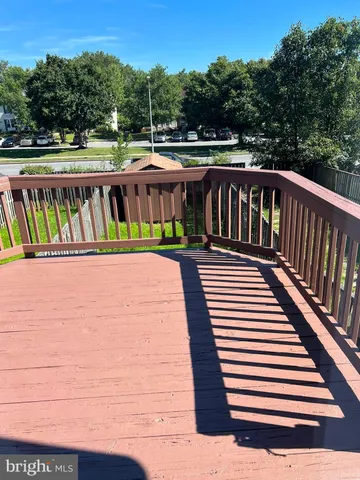 a view of a roof deck with wooden floor and fence