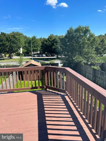 a view of a roof deck with wooden floor and fence