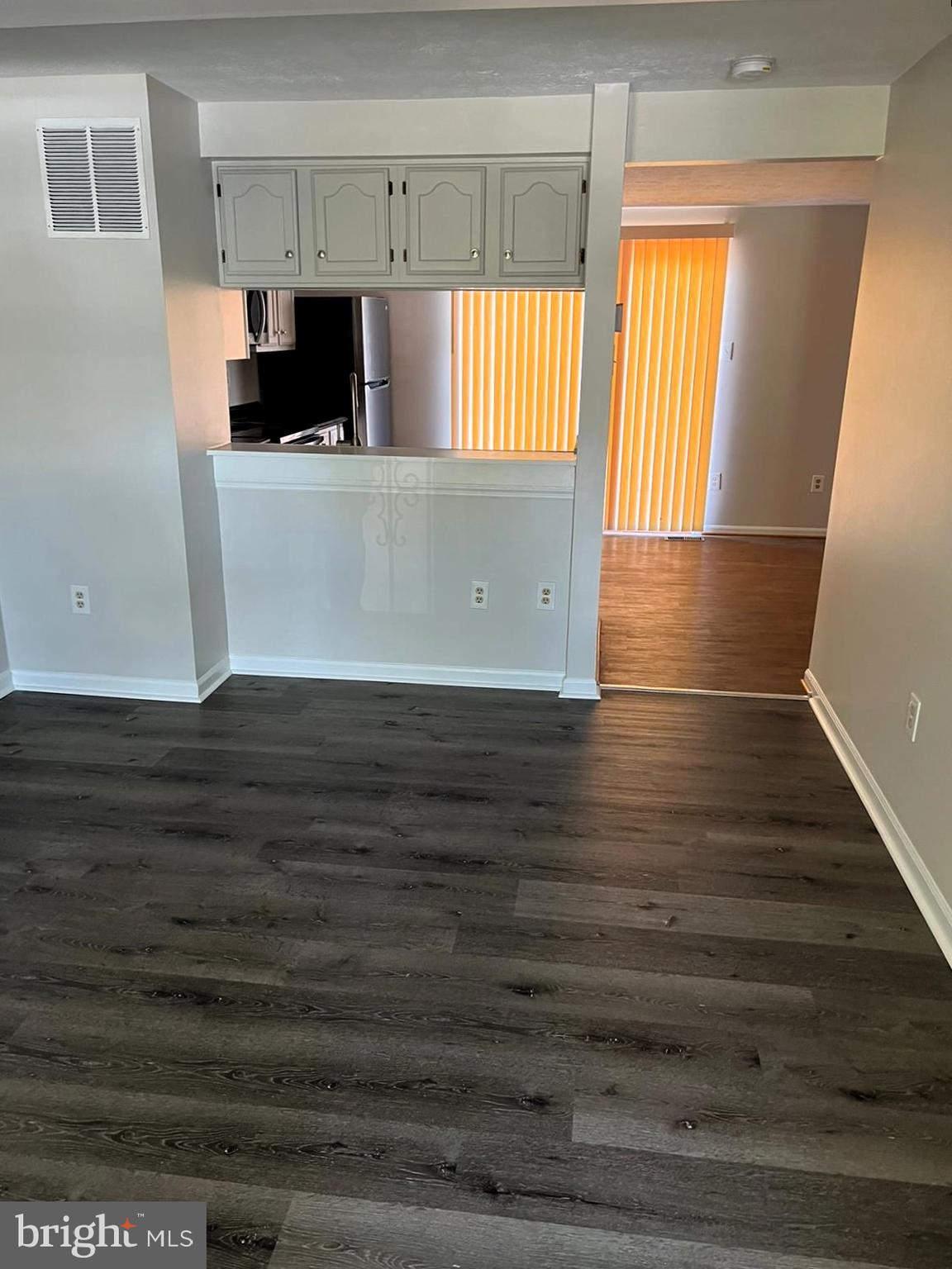 2243 Riding Crop Way Windsor Mill, MD 21244 - Photo 4 of 17 a view of kitchen and empty room with wooden floor
